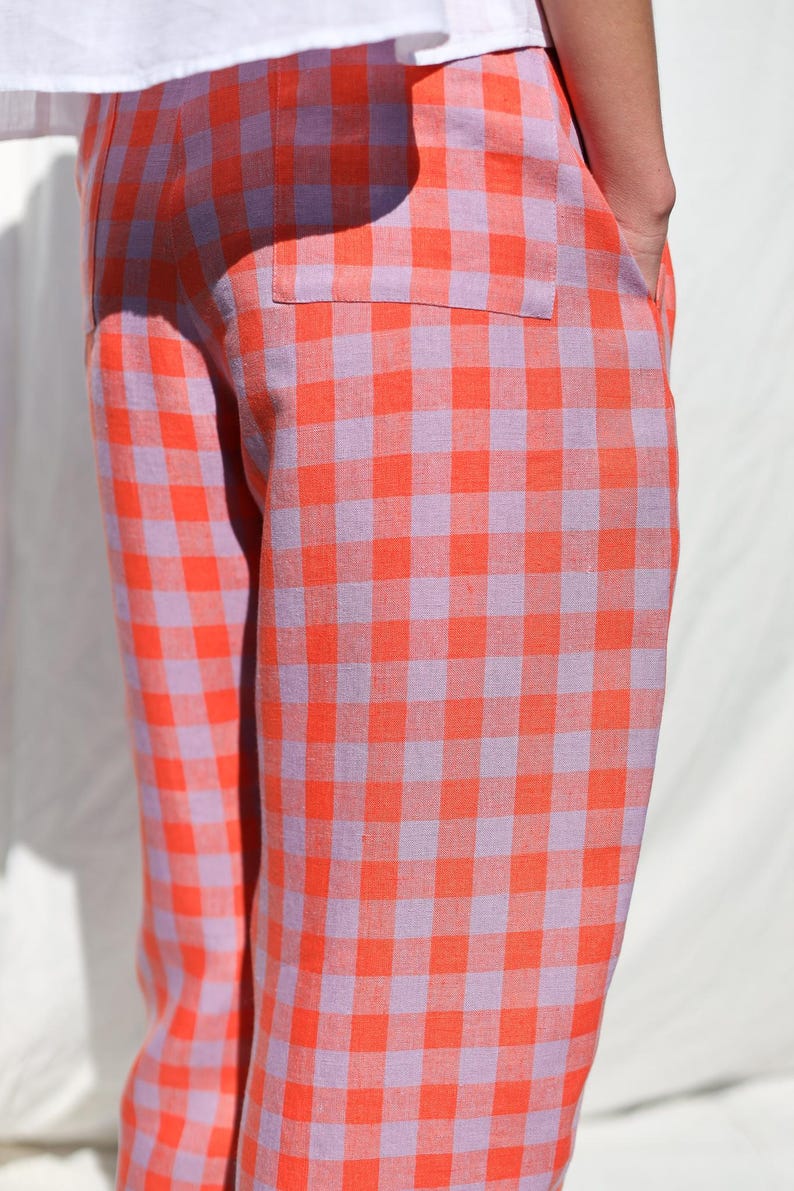 May include: Orange and purple gingham pants with a wide leg silhouette.