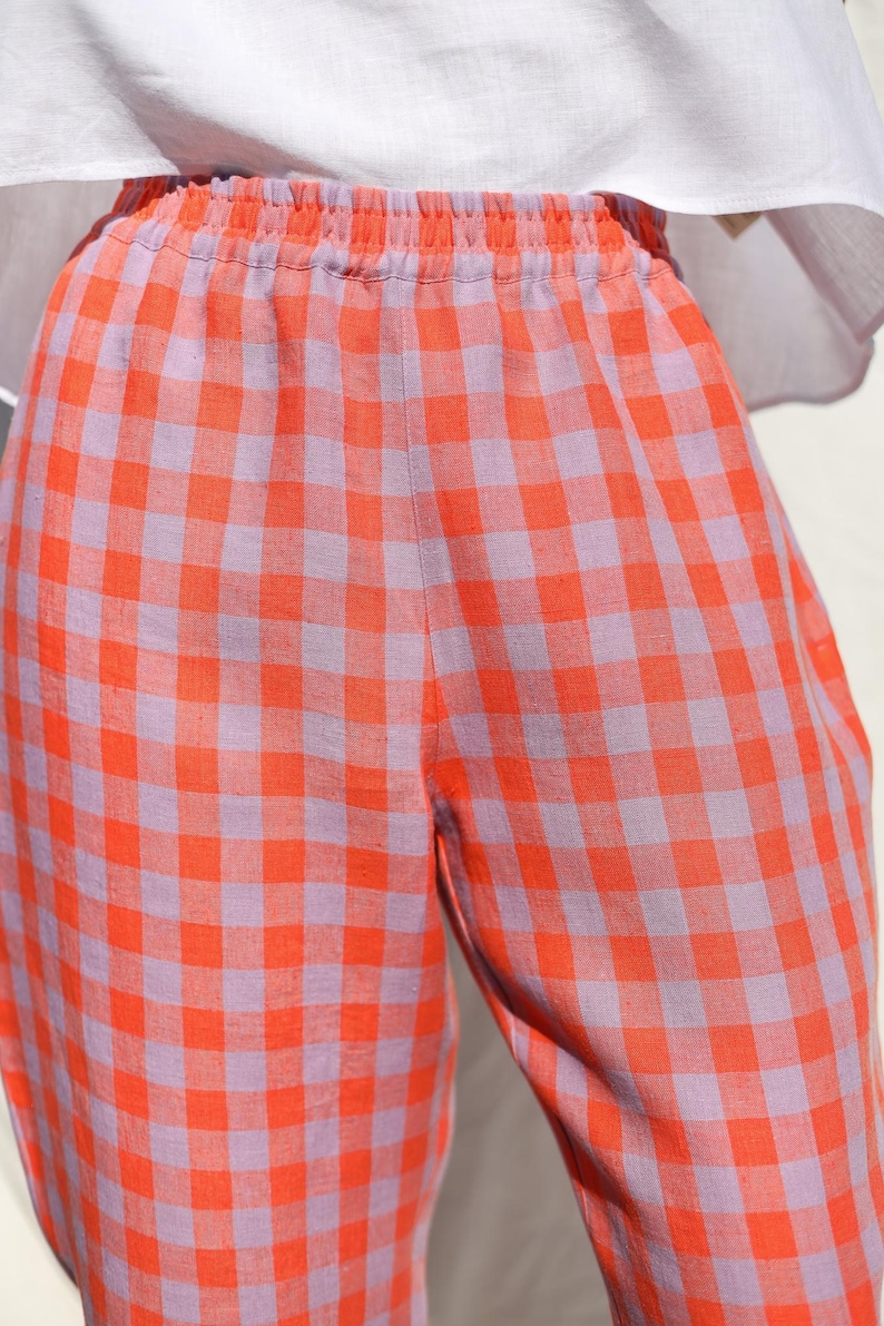 May include: Orange and purple gingham pants with an elastic waistband.