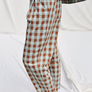 May include: Brown and light blue checkered pants with a wide leg and a cropped length.