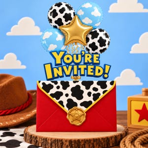 May include: A red envelope with a black and white cow print flap, sealed with a gold star-shaped wax seal. Above it, a cluster of balloons includes two cow print, two blue cloud-patterned, and one gold star balloon with the text You're INVITED!