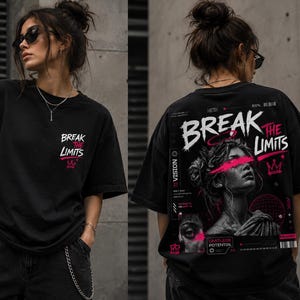 May include: A black short-sleeved t-shirt featuring a small graphic on the front left chest that reads "BREAK THE LIMITS" in white and pink. The back displays a large, detailed graphic of a classical statue with pink accents and text.