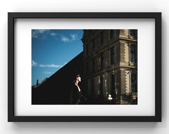 Street photography in Paris: Elegant woman in front of the Louvre museum, captivating play of light. Wall art, interior design