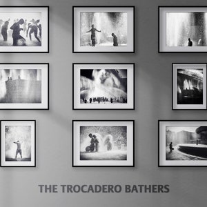 May include: A black and white photo collage of people playing in a fountain. The photos are framed and hung on a wall. The text "THE TROCADERO BATHERS" is printed below the photos.