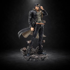 May include: A detailed figurine of a male character wearing a long black coat, matching trousers, and a peaked cap. The figure stands on a textured, rocky base with debris, featuring a grey undershirt, a gold chain, and a multi-colored belt.
