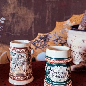 Antique German Kinderkrug Mini Stein Pair | Dem Guten Kinde Child’s Mugs | Relief Folk Scene Pottery | Missing Lids