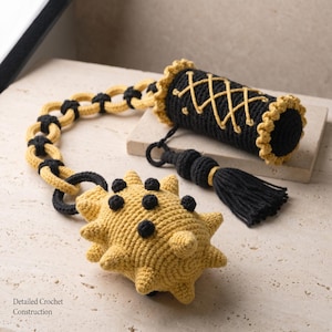 May include: A yellow and black crocheted flail toy featuring a spiked ball connected by a chain to a cylindrical handle. The handle has a black base with yellow crisscross lacing and a black tassel. The text Detailed Crochet Construction is visible.