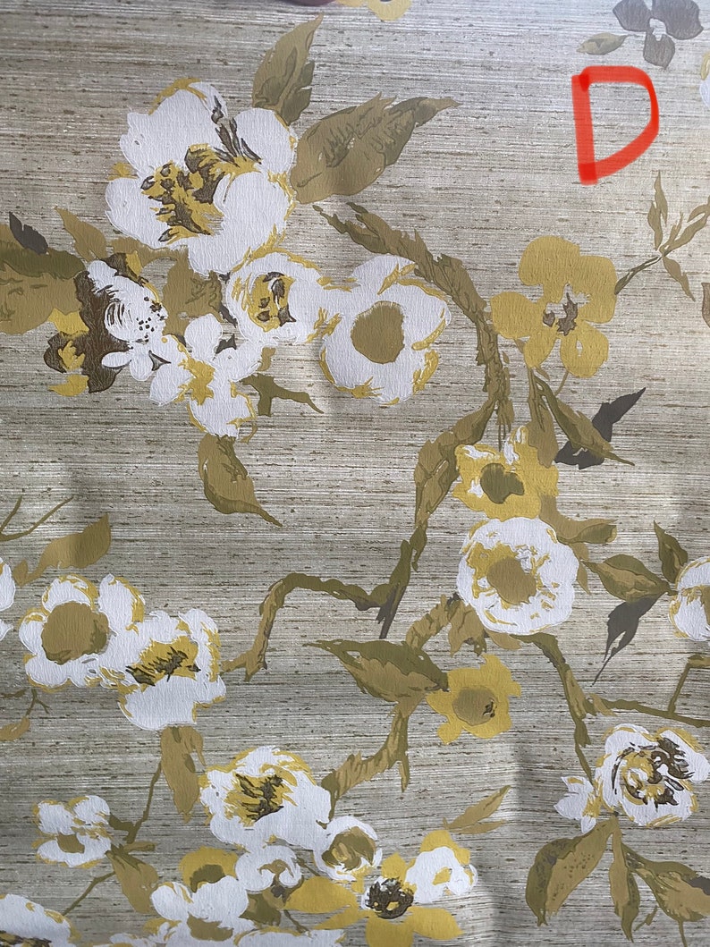 May include: A beige fabric with a white and yellow floral pattern. The fabric has a subtle texture and a slightly distressed look.