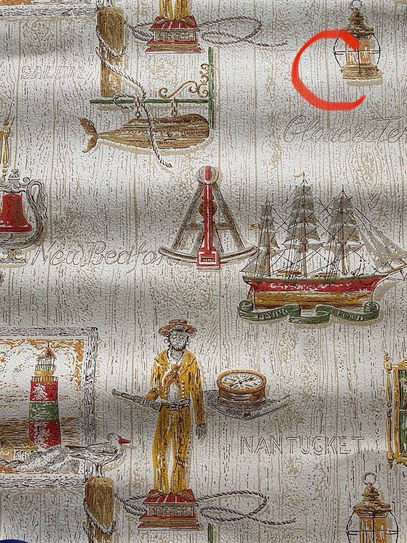 May include: Vintage wallpaper with a nautical theme. The wallpaper features a variety of nautical imagery, including ships, lighthouses, anchors, and seagulls. The wallpaper is printed on a beige background with a woodgrain texture. The text "Salem", "New Bedford", "Gloucester", "Flying Cloud", and "Nantucket" is printed on the wallpaper.
