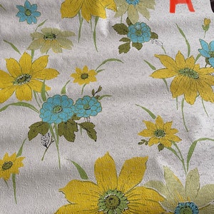 May include: White wallpaper with a floral pattern featuring yellow, green, and blue flowers. The flowers are stylized and have a retro look. The wallpaper has a textured surface.
