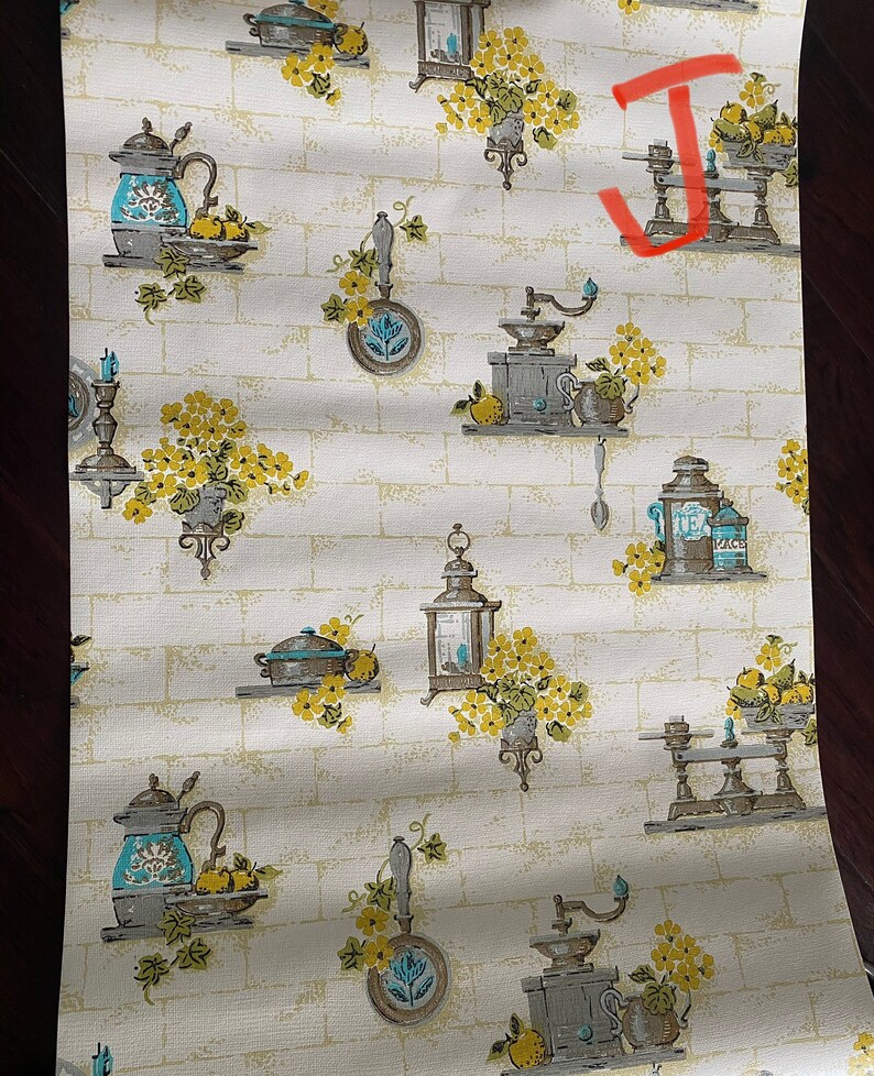 May include: Vintage kitchen wallpaper with a white brick background and a repeating pattern of blue and gray kitchenware, yellow flowers, and lemons.