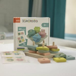 May include: A wooden educational toy set featuring a white box labelled Igroteco with 20 tasks and 16 figures. The set includes a square wooden base with vertical pegs and various geometric shapes in muted colours like green, pink, and yellow.
