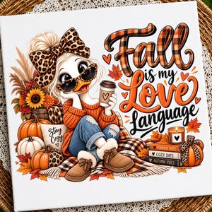Peut inclure: Une impression sur toile carrée représentant un canard de dessin animé avec un nœud et des lunettes de soleil à motif léopard, tenant une tasse de café. Le texte indique Fall is my Love Language. On y voit des citrouilles, des livres et des feuilles.