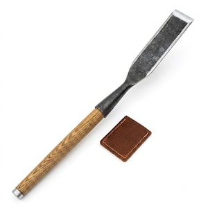May include: A woodworking chisel featuring a long, textured wooden handle with a metallic end cap and a dark, forged steel blade with a polished edge. Beside the chisel lies a small, rectangular brown leather protective sheath with stitching.