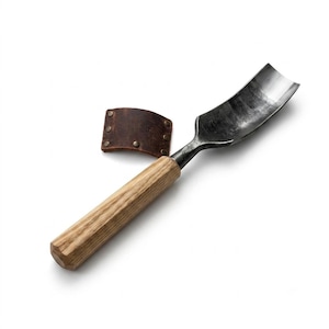 May include: A hand tool featuring a curved, dark metal gouge blade attached to a light-colored, cylindrical wooden handle. Beside the metal blade lies a small, rectangular piece of dark brown leather secured with four metallic rivets.