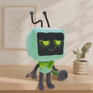 May include: A plush toy shaped like a television with a light mint green head and body, dark gray limbs, and two antennae. The screen is black with embroidered lime green eyes and a smirk. It wears a lime green bow tie and holds a gray microphone.