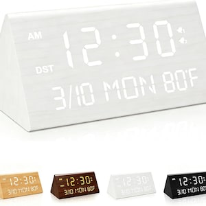 May include: A triangular digital alarm clock with a white wood grain finish and a bright white LED display showing the time 12:30, AM, DST, the date 3/10, the day MON, and the temperature 80F. Four color variations are shown below the main clock.