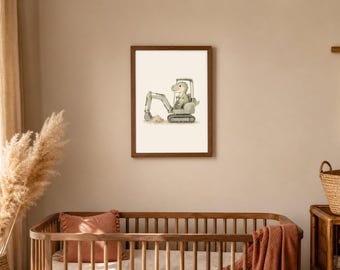 May include: A framed wall art print featuring a watercolor illustration of a light green dinosaur operating a grey construction excavator. The dinosaur is positioned inside the cab of the vehicle, which is depicted digging into a small pile of dirt.