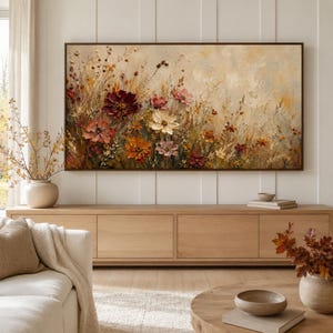 May include: A rectangular wall art canvas featuring an impasto oil painting of a wildflower meadow. The artwork displays a palette of deep burgundy, burnt orange, soft pink, and cream flowers set against a textured, neutral beige background.