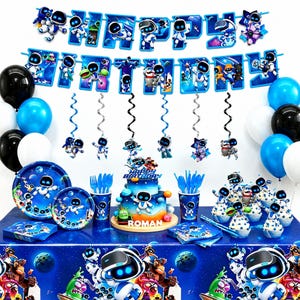 May include: A party decoration set featuring Astro Bot characters, including a Happy Birthday banner, blue and black balloons, hanging swirls, paper plates, cups, napkins, and a two-tier cake topper with the name Roman on a blue space background.