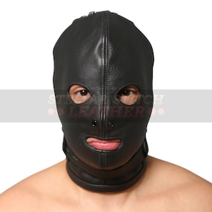 May include: A black leather hood featuring a full-head design with cutouts for the eyes, nose, and mouth. The mask includes visible stitching along the center seam and a thick integrated collar strap at the base, providing a secure fit around the neck.