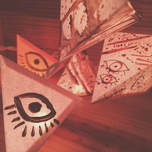 Paper Pyramid Light Garland - EVIL EYE - handmade paper lanterns w/ hand painted eyes, pinhole cutouts, speckled & cream paper w/ cocoa inks