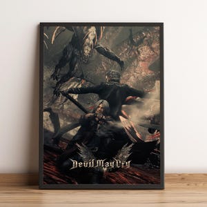 May include: A framed poster featuring a dark, action-oriented scene from Devil May Cry. The artwork displays two silver-haired figures in combat against a large, shadowy creature. The title Devil May Cry is printed in white at the bottom center.