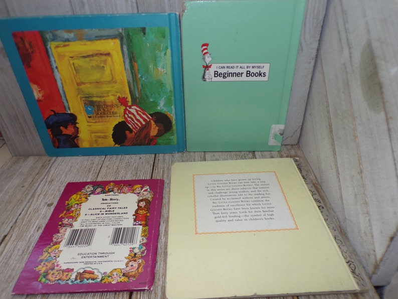 May include: Four children's books with colorful covers. The first book has a blue cover with a picture of a door and three children. The second book has a green cover with the text "I Can Read It All By Myself Beginner Books". The third book has a purple cover with the text "Classical Fairy Tales of Alice in Wonderland". The fourth book has a yellow cover with text about the book.