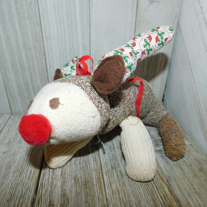 May include: A set of three ceramic mugs with a speckled, matte finish. The mugs are in shades of cream, light gray, and dark gray. Each mug has a simple, minimalist design and a rounded handle.