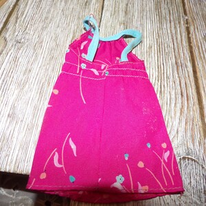 May include: A pink sleeveless dress with a floral print and blue straps. The dress is made of a soft, lightweight fabric.