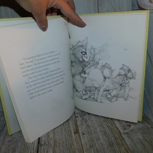 May include: A black and white illustration of a man with a basket on his back. A creature with a long snout and large ears is reaching into the basket with its hand. The man is looking down at the creature. The text in the image reads: "I'm going to lighten your load a little," he said. "I'm going to relieve you of that basket." He shoved one pistol back into his belt and proceeded to unite the basket with his free hand.