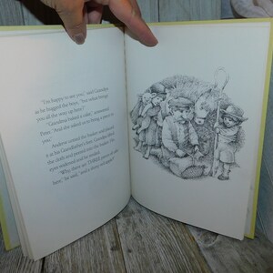 May include: A black and white illustration of a group of children standing around a basket. The children are looking into the basket. The text in the image reads, "I'm happy to see you," said Grandpa as he hugged the boys, "but what brought you all the way up here?" Grandma baked a cake, answered Peter. "And she asked us to bring a piece to you."