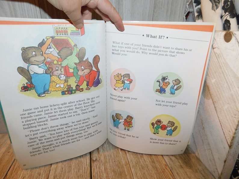 May include: A children's book page with illustrations of animals playing with toys. The text asks "What if?" and presents a scenario where a friend doesn't want to share their toys. The reader is asked to choose which picture shows the best way to handle the situation.