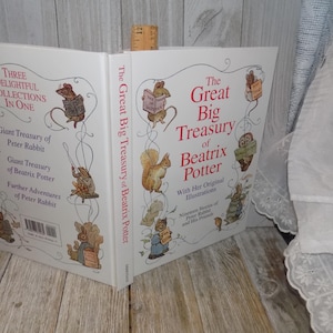 May include: A white hardcover book titled "The Great Big Treasury of Beatrix Potter" with illustrations of Peter Rabbit and his friends. The book includes three collections: Giant Treasury of Peter Rabbit, Giant Treasury of Beatrix Potter, and Further Adventures of Peter Rabbit.