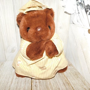 May include: Brown plush teddy bear wearing a yellow and brown striped sleepwear with the text "Papa's Max" printed on it.