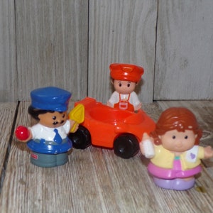 May include: A set of three Little People figurines, including a police officer holding a red ball, a construction worker in an orange jumpsuit sitting in a red car, and a girl with brown hair holding a bottle.