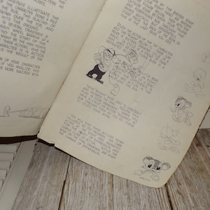 May include: Vintage animation guide with detailed illustrations and text. The pages show sequential drawings of cartoon characters in motion, including walking and running cycles. The guide is designed to teach animation techniques.