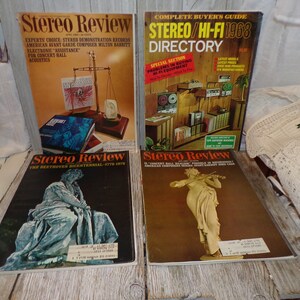 May include: Four vintage copies of Stereo Review magazine. The covers feature a scale with a record, a statue of Beethoven, a woman playing a violin, and a directory of stereo and hi-fi equipment.