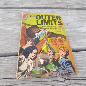 May include: Vintage comic book titled "The Outer Limits" with a colorful cover illustration. The cover features a large ape-like creature, a woman, and a man with a ray gun. The comic book is set against a yellow and orange background.