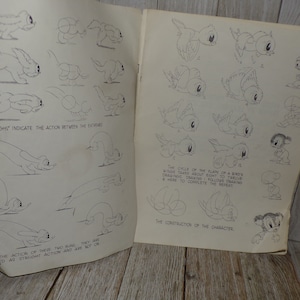 May include: Open book with pencil sketches of cartoon animals and birds in various poses. Text includes "The 'roughs' indicate the action between the extremes" and "The cycle of the flaps of a bird's wings takes about eight to twelve drawings."