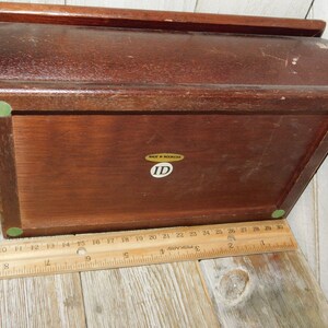 May include: A wooden box with a hinged lid. The box has a green felt lining and a label that reads "MADE IN INDONESIA" and "ID".