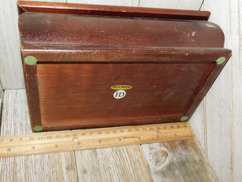 May include: A wooden box with a hinged lid. The box has a green felt lining and a label that reads "MADE IN INDONESIA" and "ID".