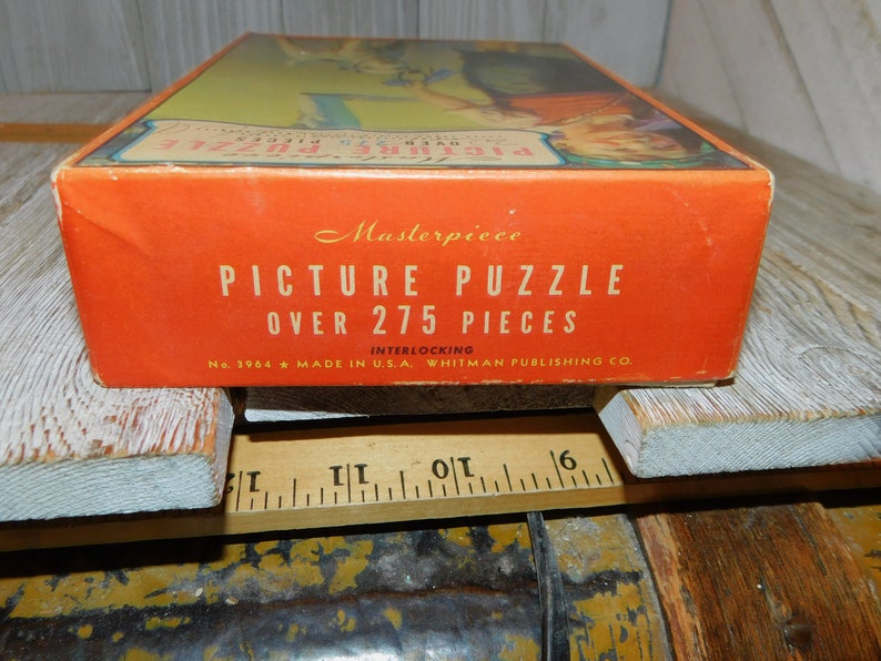 May include: A red box with the text "Masterpiece Picture Puzzle Over 275 Pieces Interlocking No. 3964 Made in U.S.A. Whitman Publishing Co."