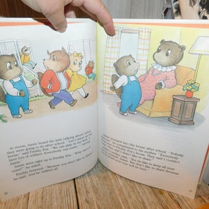 May include: An illustrated children's book page featuring a group of brown bears playing on a jungle gym and a family of bears in their home. The text on the page reads, "At recess, Jamie heard the kids talking about what they were going to do after school. "Let's meet at my house," said Freddy Fox. "We can play in my fort. I have lots of soldiers. Everybody can come."  "Why can't I come?" Jamie asked. Freddy frowned. "Because you don't like to share." he said. And he walked off."