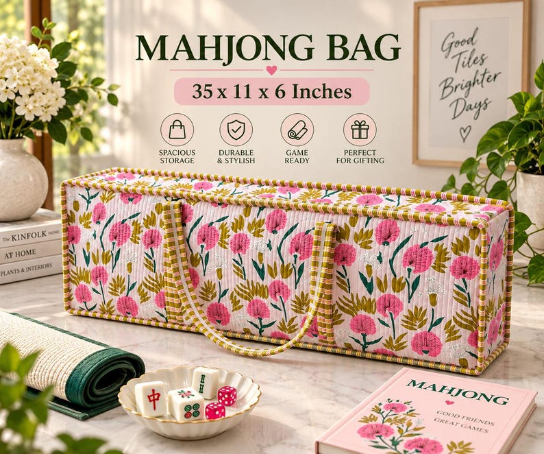 May include: A rectangular quilted mahjong bag featuring a pink and green floral pattern with a yellow and white checkered trim. The bag measures 35 x 11 x 6 inches and includes two matching fabric handles for carrying the game set.