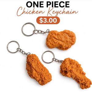 May include: Three keychains featuring realistic, golden-brown, breaded chicken pieces attached to silver-toned metal split rings and short chains. The text ONE PIECE Chicken Keychain is displayed at the top of the image with a price tag of $3.00.