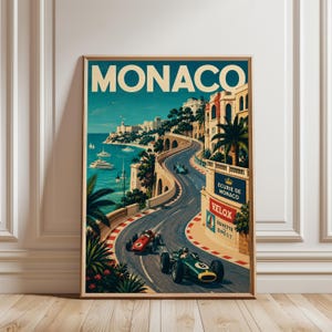 May include: A vintage-style travel poster titled MONACO featuring a winding coastal race track with two classic open-wheel race cars, one red and one green, driving along the Mediterranean sea with yachts and buildings in the background.
