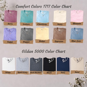 May include: A color chart displaying Comfort Colors 1717 and Gildan 5000 t-shirts. The Comfort Colors section shows shirts in berry, seafoam, chambray, ivory, blossom, violet, pepper, butter, espresso, and blue jean. The Gildan section shows white, sport grey, dark heather, black, navy, and sand shirts.
