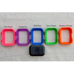 May include: Five rectangular protective frames in neon pink, purple ice, bold blue, limer green, and mystery orange, arranged in a row above a single black rectangular device with the letters fi embossed on the front surface.