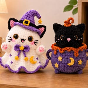 May include: Two crocheted plush toys: a white ghost cat wearing a purple witch hat with a yellow star, and a black cat sitting inside a purple cauldron with orange trim. Both figures feature embroidered yellow stars and crescent moon details.