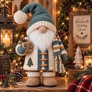 May include: A crocheted gnome figurine wearing a teal hat with a white pom-pom, a white coat with three wooden toggles, and brown boots. The gnome has a long white beard, holds a small gift box with a tree print, and wears a striped scarf.